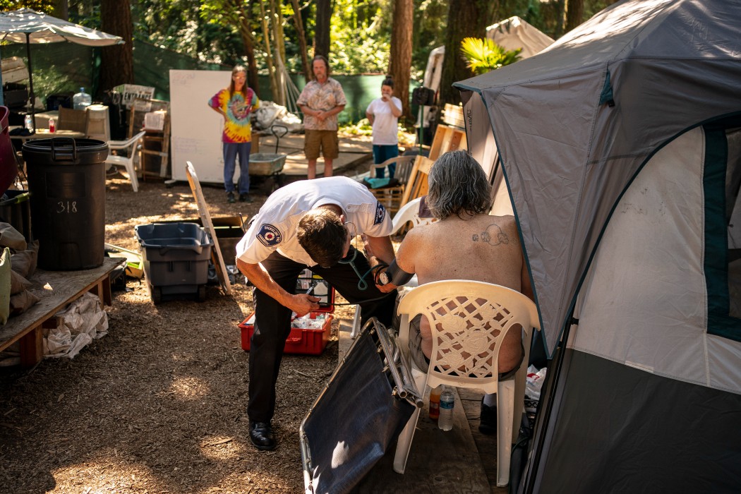 A medical services officer with the Shoreline Fire Department checked a man’s blood pressure last week during a record-breaking heat wave in Shoreline, Wash.Credit...David Ryder/Getty Images